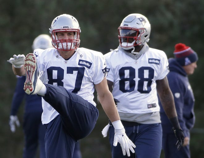 New England Patriots tight ends Rob Gronkowski and Martellus Bennett warm up during a practice last season. Bennett will be a free agent. [Steven Senne/The Associated Press]