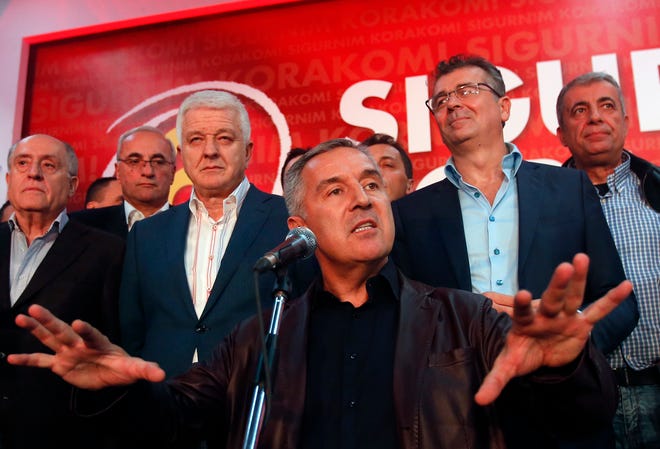 In this Monday, Oct. 17, 2016 file photo, former Montenegro’s Prime Minister and long-ruling Democratic Party of Socialists leader Milo Djukanovic, center, speaks in his headquarter, in Podgorica, Montenegro. Montenegro’s special prosecutor Milivoje Katnic, has accused Russia and its secret service operatives of plotting a coup attempt that included plans to kill the small Balkan country’s former prime minister, Milo Djukanovic, following an investigation. (AP Photo/Darko Vojinovic, File)