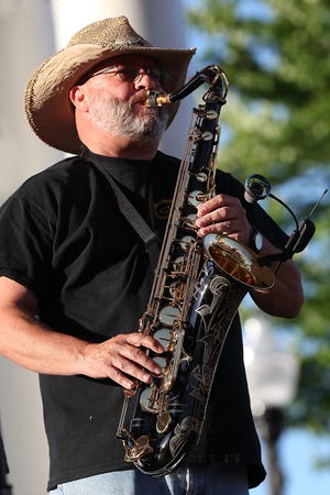 Joey Dunlevy plays the saxophone for Coming Up Brass in May 2016 during the Gastonia Downtown Summer Concert Series. [JOHN CLARK/THE GAZETTE]