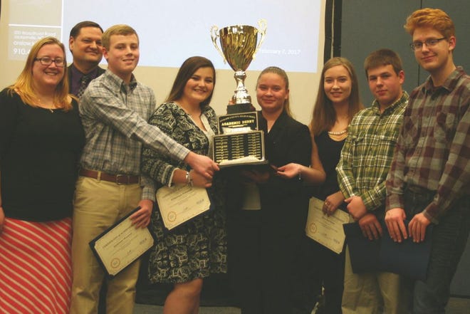 From left, Coach Ashleigh DeMartin, Jamison Weaver, Rhiannon Schmidt, Danielle Gartman, Alex Gartman, and Nick Sanders accept the high school Academic Derby trophy last week after going undefeated in the 2016 season. Not pictured are teammates Kittrece Cade and Pauly Herrera. Contributed photo.