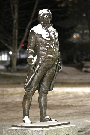 Light snowfall accumulates on the John Adams statue at Quincy City Hall last month.,