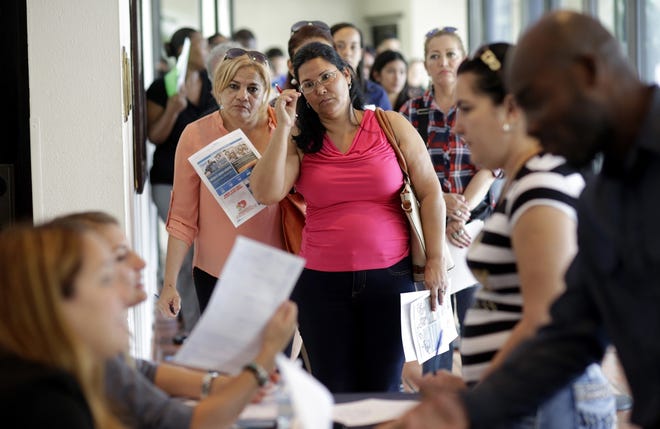 Applicants stand in line at a job fair in Miami Lakes. (AP File Photo / 2016)