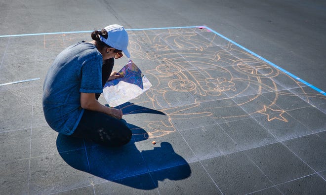 Maaria Kader, from California, works on the outline of her work for the 2016 Sarasota Chalk Festival. [HERALD-TRIBUNE STAFF PHOTO / RACHEL S. O'HARA]