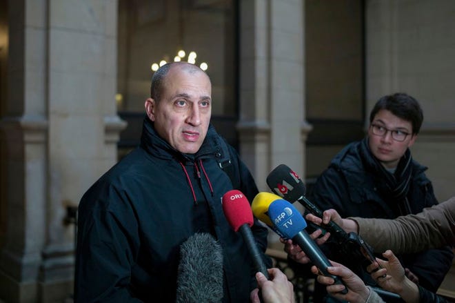 Chief suspect Vjeran Tomic faces the media at court for his trial in Paris, Monday, accused of involvement in one of the world's biggest art heists. (AP Photo/Thibault Camus)