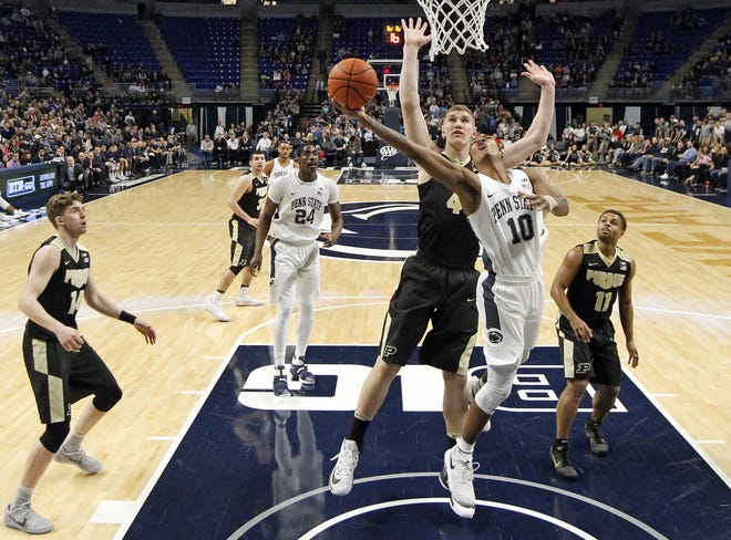 Penn State's Tony Carr drives to the basket in front of Purdue's Isaac Haas during the first half Tuesday's game in State College, Pa.