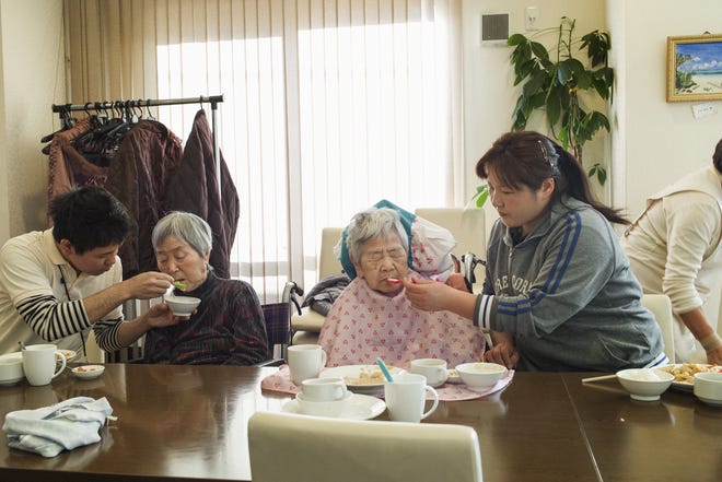 Nursing home residents are fed at the Chinese restaurant Kaze no Oto in Yokohama, Japan. It is one of a few restaurants in Japan catering to an aging population. [KENTARO TAKAHASHI / THE NEW YORK TIMES]