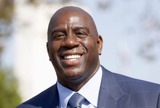In a Tuesday, Aug. 23, 2016, photo, former Los Angeles Lakers star Magic Johnson speaks at a groundbreaking ceremony. The Los Angeles Lakers fired general manager Mitch Kupchak on Tuesday, Feb. 21, 2017, and put Magic Johnson in charge of basketball operations. THE ASSOCIATED PRESS