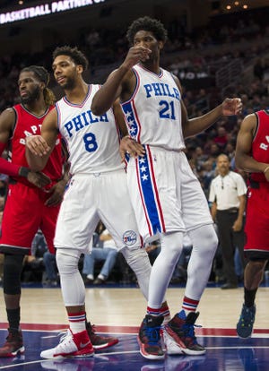 (File) The Sixers' Jahlil Okafor (8) and Joel Embiid (21) establish inside position during a Dec. 14 home loss to the Raptors.