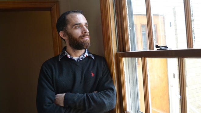 In a Wednesday, Feb. 1, 2017 photo, Tyler Witten peers through a window at the Sanibel House, a residential addiction center in Catlettsburg, Ky. Witten, a former opioid addict, has gone through an addiction program and now works as a weekend staffer at the house. The house and other centers are operated by Addiction Recovery Care, which is seeing many new patients who are covered under Kentuckys Medicaid expansion as part of the Affordable Care Act. (AP Photo/Dylan Lovan)