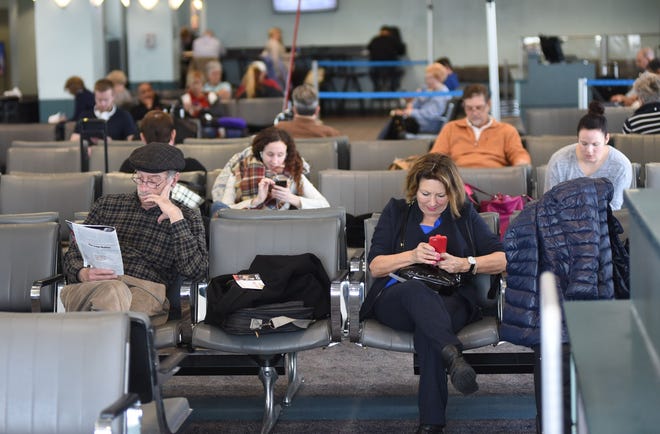 Passengers wait at the gates to board their flights at Wilmington International Airport earlier this month. Respondents to a community survey said the airport's customer's were happy with the facility, but want more destinations and upgraded concessions. [Matt Born/StarNews Photo]