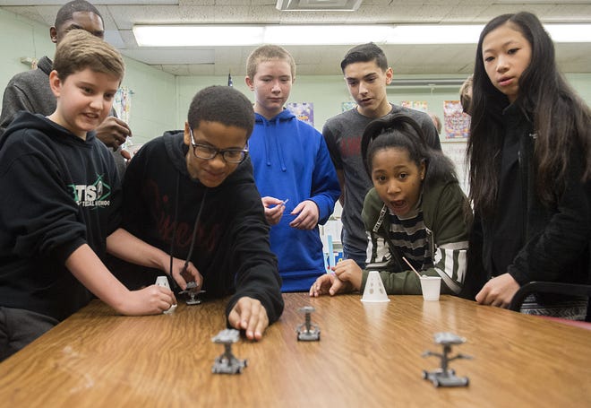 Neil A. Armstrong Middle School eighth-grader Ivy Peterson (second from right), 13, reacts to her and her partner, Erika McCullough (right), 13, winning a robotics race after making robots for National Engineers Week at the school in Bristol Township on Thursday, Feb. 23, 2017. The school, one of two in the area that are deemed Verizon Innovative Learning Schools, had engineers from Verizon come by to discuss robotics and engineering with the kids.