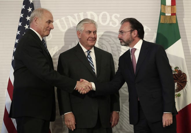 U.S. Secretary of State Rex Tillerson, center, smiles as Mexico's Foreign Relations Secretary Luis Videgaray, right, shakes hands with U.S. Homeland Security Secretary John Kelly at the Foreign Affairs Ministry in Mexico City, Thursday, Feb. 23, 2017. Mexico's mounting unease and resentment over President Donald Trump's immigration crackdown are looming over a Thursday meeting between Tillerson, Homeland Security Secretary John Kelly, and Mexican leaders that the U.S. had hoped would project a strong future for relations between neighbors. (AP Photo/Rebecca Blackwell)
