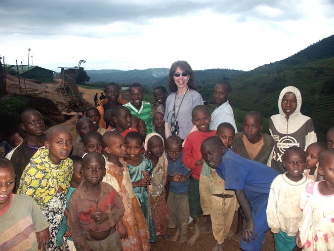 World Without Genocide activist Dr. Ellen Kennedy lends support to children in a Rwandan refugee camp. [Provided by Ellen Kennedy]