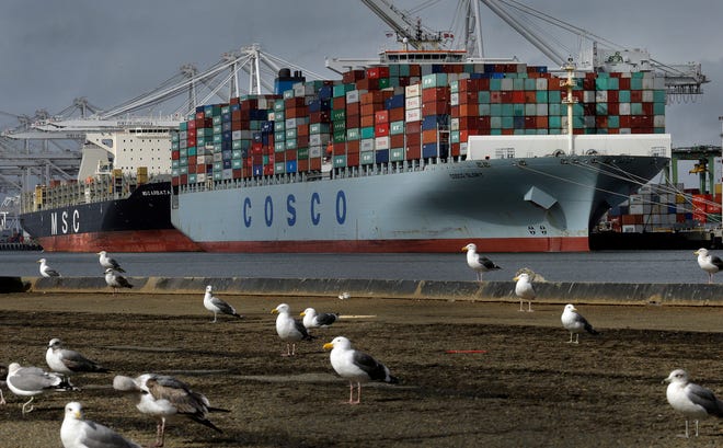 In this Friday, Feb. 3, 2017, file photo, the Chinese container ship Cosco Glory waits to be unloaded at the Port of Oakland in Oakland, Calif. According to information released Tuesday, Feb. 7, 2017, by the Commerce Department, the U.S. trade deficit narrowed slightly in December 2016, but the improvement wasn’t enough to keep the deficit for the entire year from rising to the highest level since 2012. (AP Photo/Ben Margot, File)