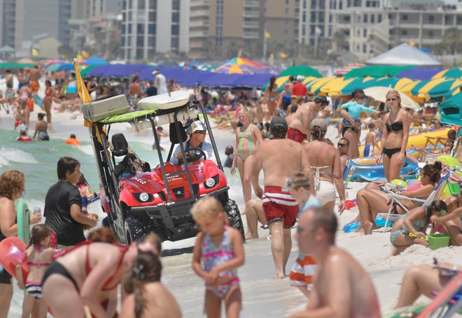 A lifeguard patrols a crowded section of beach in Destin in this Daily News file photo.

[DAILY NEWS FILE PHOTO]