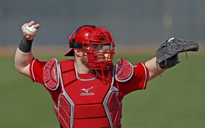 Cincinnati Reds catcher Tucker Barnhardt gets ready to throw the baseball back to a pitcher at the Reds baseball spring training facility in Goodyear, Ariz. In order to speed up the game, baseball will no longer require the pitcher to throw four balls to the catcher for an intentional walk. [THE ASSOCIATED PRESS / ROSS D. FRANKLIN]