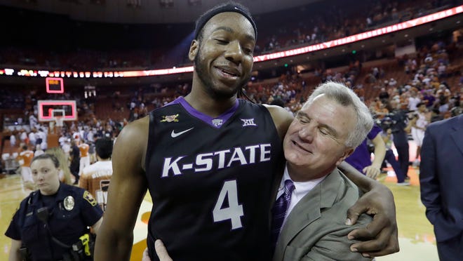 Kansas State forward D.J. Johnson (4) celebrates with head coach Bruce Weber after he hit the winning shot in the final seconds of the second half of an NCAA college basketball game against Texas, Saturday, Feb. 18, 2017, in Austin, Texas. Kansas State won 64-61. (AP Photo/Eric Gay)