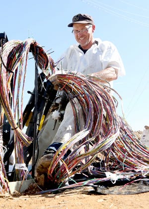 Jonathan Moen with AT&T works to splice telephone cables Thursday, Feb 23, 2017, at Buske Drive and Geren Road in Fort Smith. [JAMIE MITCHELL/TIMES RECORD]