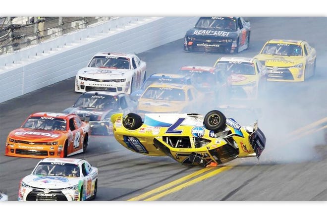 TROUBLE — Regan Smith (7) flips during a crash in the NASCAR XFINITY series race at Daytona International Speedway.