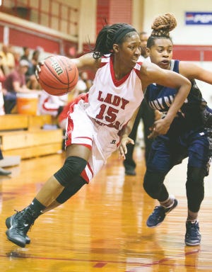 Jacksonville’s Areon Laurent drives past Northeast Guilford’s Pam Mock during the Cardinals’ 68-50 win Thursday night in the second round of the NCHSAA 3-A playoffs. Second-seeded JHS (27-1) plays host to No. 27 Corinth-Holders (14-11) Saturday at 6 p.m. at The Bird Cage.