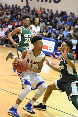 Greene Central’s DonQuez Davis is pressured by Kinston’s Tracy Whitfield during Saturday’s third round matchup between Eastern Carolina Conference rivals.