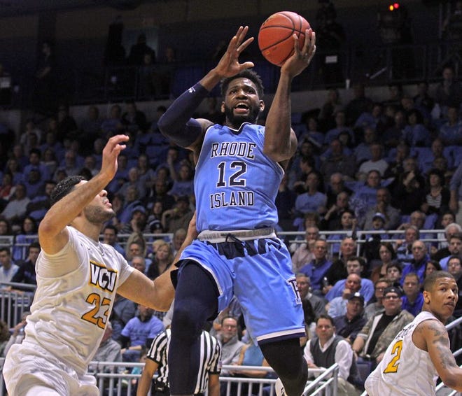 URI's Hassan Martin goes around VCU's Ahmed Hamdy-Mohamed for a layup in the first half of Saturday's game.