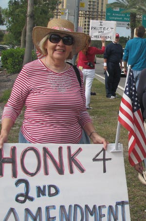 In this photo taken in January 2013, Julie Brady holds a sign supporting the Second Amendment for a Guns Across America rally along Bayfront Drive in Sarasota. Conservative activists plan a rally at the statue this weekend to show support for President Donald Trump.

[HERALD-TRIBUNE ARCHIVE / 2013]