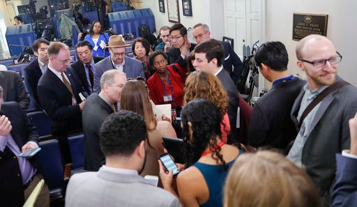 Reporters line up in hopes of attending a briefing in Press Secretary Sean Spicer's office at the White House in Washington, Friday. White House held an off-camera briefing in Spicer's office, where they selected who could attend.