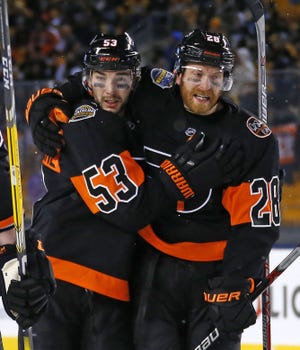 (File) Claude Giroux (right) could finish with his lowest point production in the past six seasons.