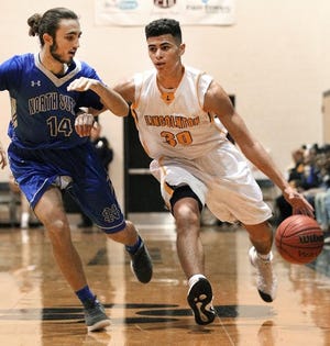 Lincolnton's Sage Surratt driving to the basket during Saturday's 94-60 N.C. 2A playoff loss to North Surry. [PHOTO BY JOHN CLARK/THE GAZETTE]