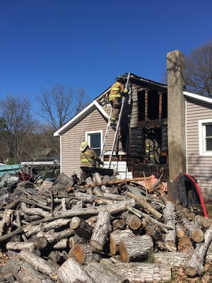 Firefighters at the scene of a house fire at 1820 Maxton Ave., which was caused by a malfunctioning wood-burning stove. [Gastonia Fire Department photo]
