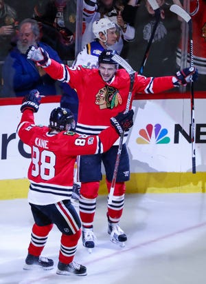 Chicago Blackhawks center Artem Anisimov (15) celebrates with right wing Patrick Kane (88) after scoring against the St. Louis Blues during the third period of an NHL hockey game Sunday, Feb. 26, 2017, in Chicago. The Blackhawks won 4-2. (AP Photo/Kamil Krzaczynski)