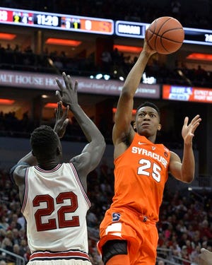 Syracuse's Tyus Battle (25) shoots over the defense of Louisville's Deng Adel (22) during the first half of an NCAA college basketball game, Sunday, Feb. 26, 2017, in Louisville, Ky.