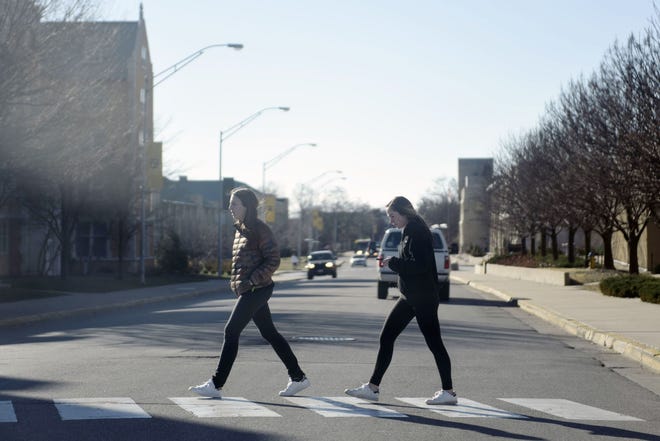 Students cross Rollins Street on Saturday. Columbia's city manager is seeking input on the city's Vision Zero policy, adopted by the city council in December, which aims to eliminate traffic deaths by 2030.