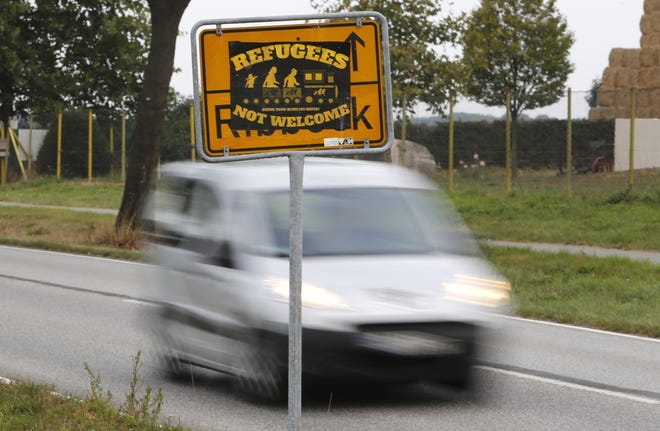The Sept. 23, 2016 shows a poster 'Refugees not welcome' sticked on a city sign in the outskirts of Nauen, eastern Germany, one of several thousand hate crimes in Germany in 2016. (AP Photo/Ferdinand Ostrop)