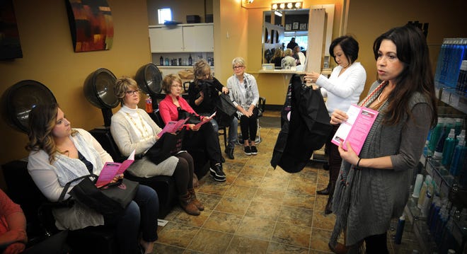 Marcela Cousens (right) and Audrey Nguyen talk about the Kansas Department of Health and Environment’s Early Detection Works program at Hair Affaire salon Monday.
