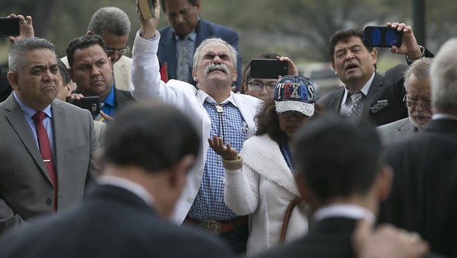 Luis and Lucy Aranda of Dallas (center) participate in the Prayer Rally for Immigrants on Tuesday outside the Captiol.