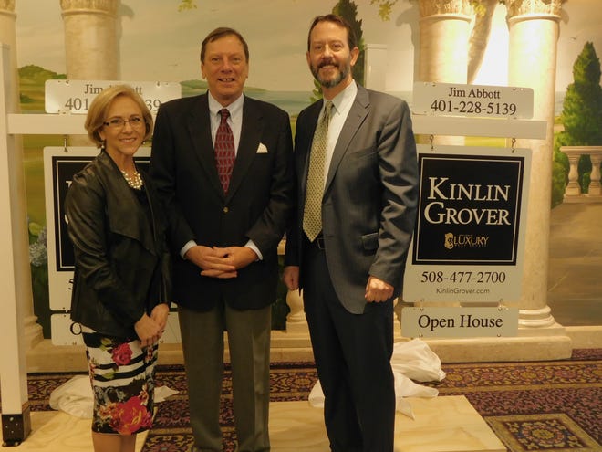 The Randall Family of Companies Director of Marketing Kathy Forrester, CEO Doug Randall and President Michael Schlott pose in front of Kinlin Grover's new signs as part of of the real estate company's new alliance with Leading Real Estate Companies of the World. Photo provided