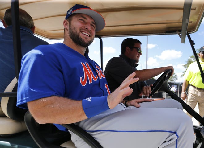 New York Mets outfielder and former NFL quarterback Tim Tebow leaves a news conference at the team's spring training facility in Port St. Lucie on Monday. [AP Photo / John Bazemore]