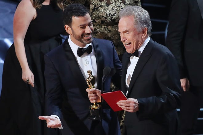 Jimmy Kimmel, host of Sunday night's 89th annual Academy Awards ceremony, talks to actor Warren Beatty during the presentation of the Best Picture Oscar. [REUTERS/Lucy Nicholson]