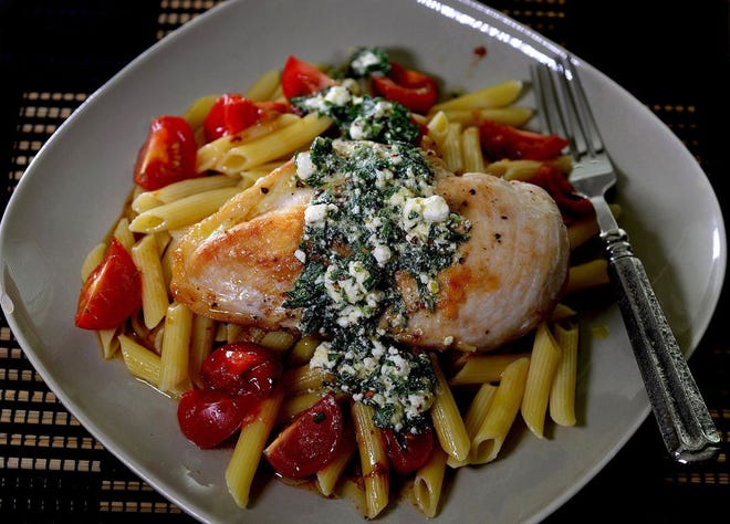 Golden brown chicken breasts top pasta with goat cheese vinaigrette.