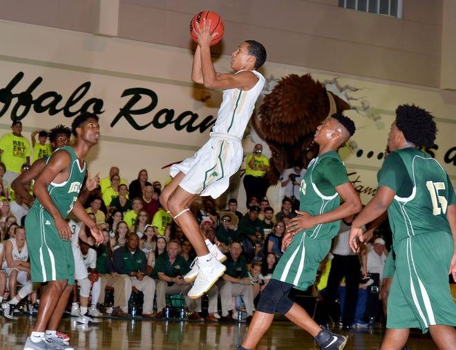The Villages' Tre Mann (2) takes a jump shot during the Class 5A-Region 2 final at The Villages Charter School on Friday. The Villages defeated Melbourne Central Catholic 68-63 to advance to Wednesday's state semifinals in Lakeland. [AMBER RICCINTO / DAILY COMMERCIAL]