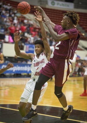 Trinity Christian's Amorie Archibald passes over Champagnat's Luis Corijo during a Class 3A state semifinal Tuesday. The Eagles face Orlando Christian Prep tonight for the state title. [THE LAKELAND LEDGER/ERNST PETERS]