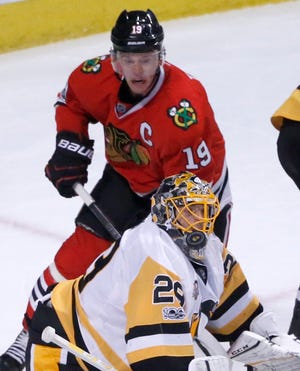 Pittsburgh Penguins goalie Marc-Andre Fleury makes a save as Chicago Blackhawks' Jonathan Toews watches during the first period of an NHL hockey game Wednesday, March 1, 2017, in Chicago. (AP Photo/Charles Rex Arbogast)