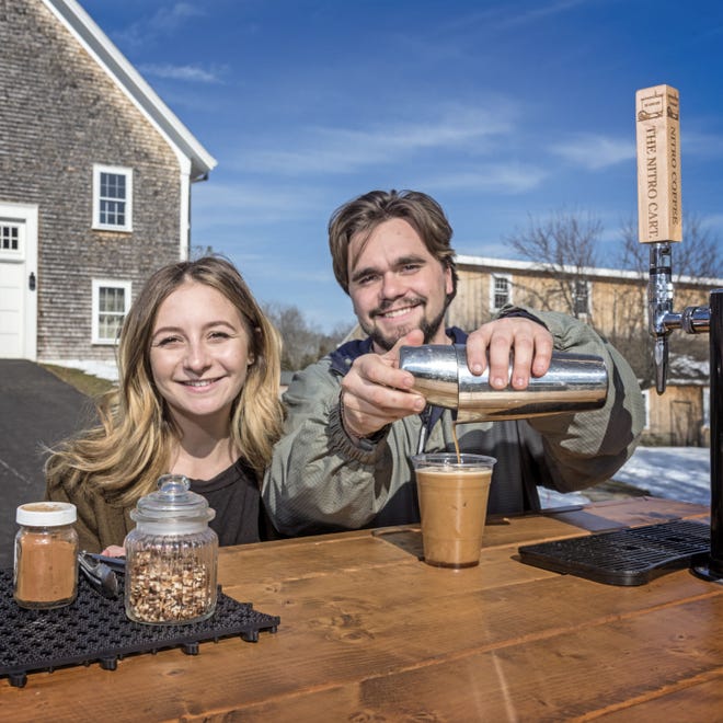 Sam Lancaster and Audrey Finocchiaro, owners of The Nitro Cart coffee cart, pour their concentrated nitro brew at the Mount Hope Farm in Bristol. Photo by Michael Salerno Photography