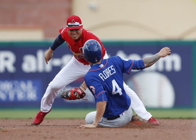 Mets' Wilmer Flores (4) is tagged out by St. Louis Cardinals shortstop Aledmys Diaz as he tries to steal second base in the second inning of Wednesday's game in Jupiter, Fla. The Mets lost 6-1. [The Associated Press]
