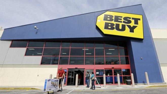 FILE - In this Tuesday, Feb. 9, 2016, file photo, a shopper carts his purchased LED TV at a Best Buy in Miami. On Tuesday, Aug. 23, Best Buy reports financial results. (AP Photo/Alan Diaz, File)