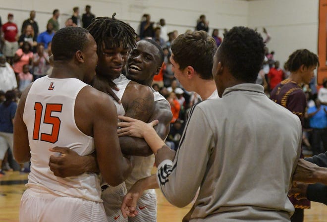 Leesburg players react after winning a Class 6A regional final against Hallandale High School in overtime in Leesburg on Friday. [PAUL RYAN / CORRESPONDENT]