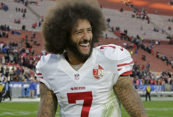 Colin Kaepernick caused a major stir and started a small trend last year. AP FILE