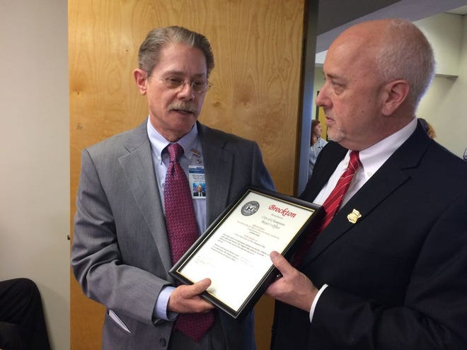 Henry Julio East-Trou (left), executive director of the Gandara Center, was honored with a framed certificate of appreciation from Brockton Mayor Bill Carpenter at the nonprofit's Crescent Street office in Brockton during the one-year anniversary celebration of The Champion Plan on Thursday, March 2, 2017.